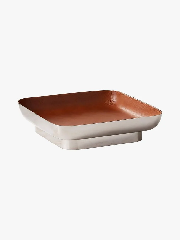 Square tray with stainless steel exterior and brown leather interior.