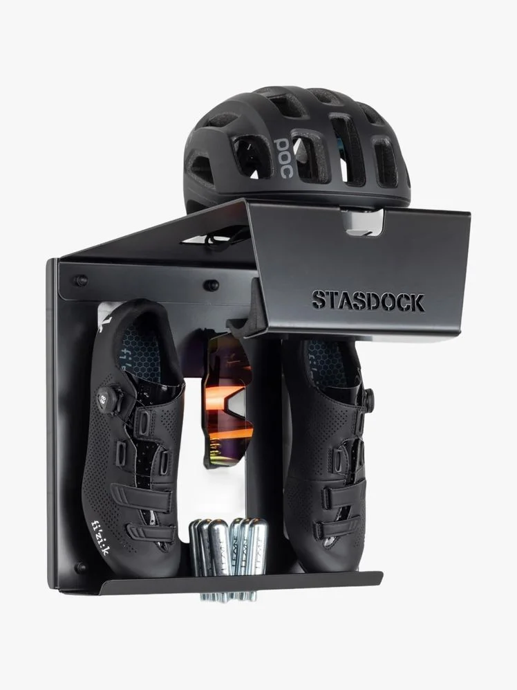 Wall mount with shoes, bike helmet, and accessories held in it.