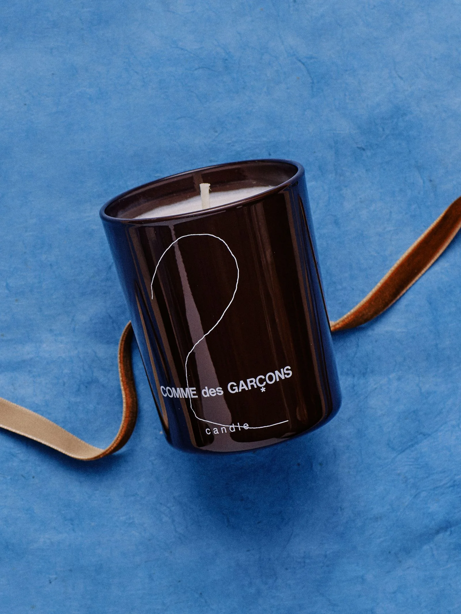 Heres a candle to bring his apartment one step closer to Dover Street Marketlevel cool. Housed in a container he can...