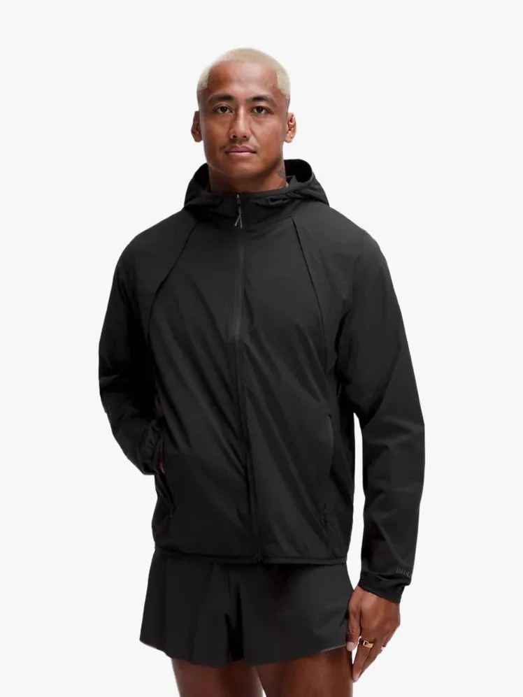 Person wearing a black zippered jacket.