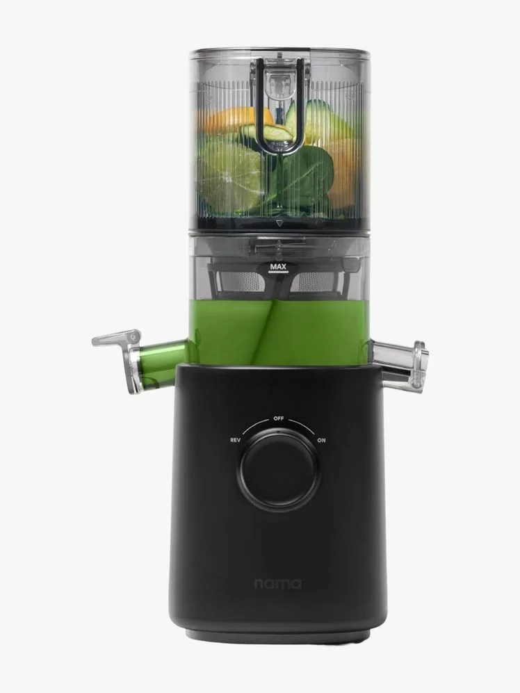 Cold Press Juicer with vegetables inside.