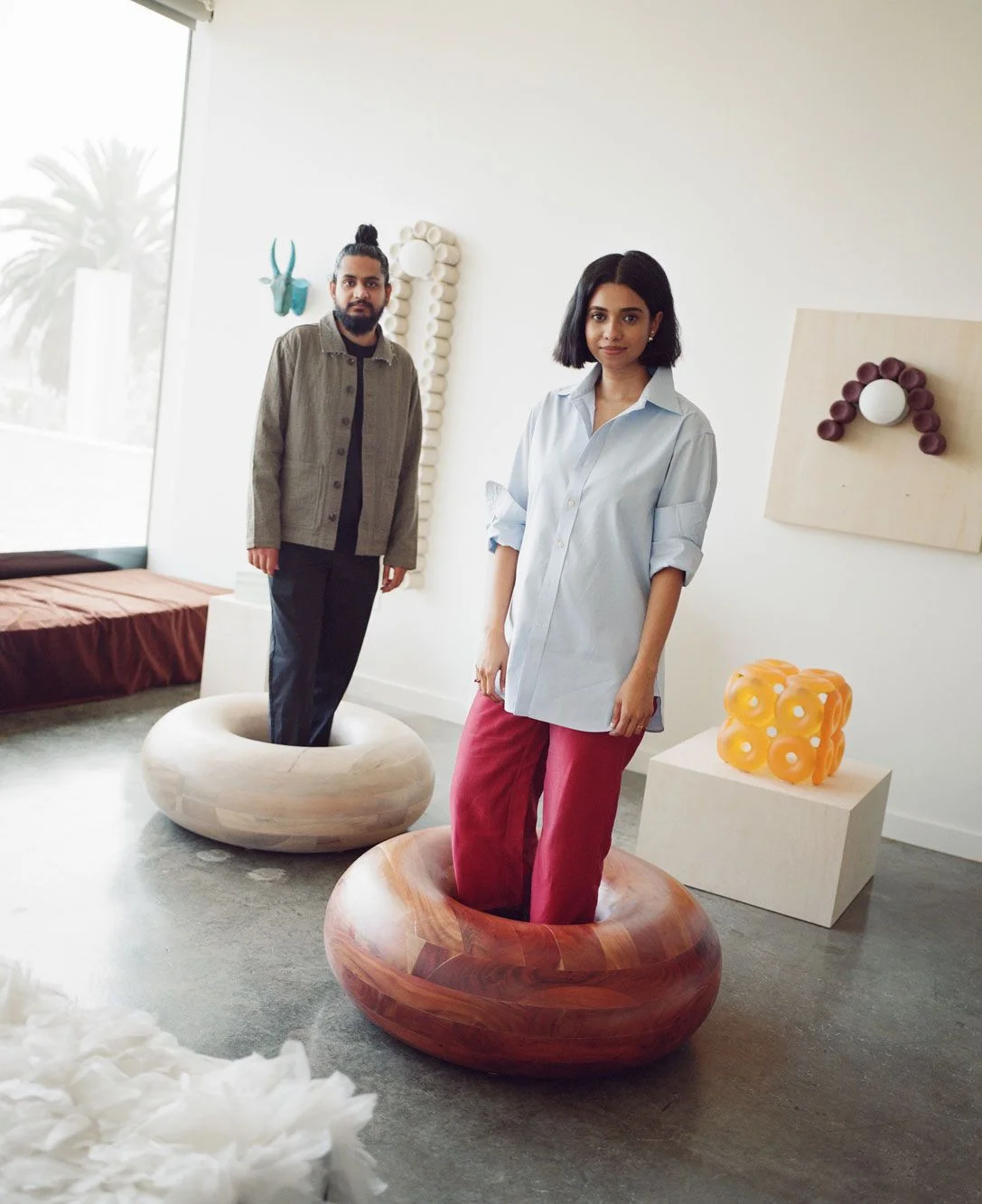 Image may contain Eshita Mehboob Adhir Kalyan Clothing Pants Sleeve Adult Person Furniture Table and Pajamas