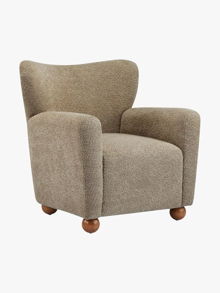 Sherpa wingback chair with spherical feet.