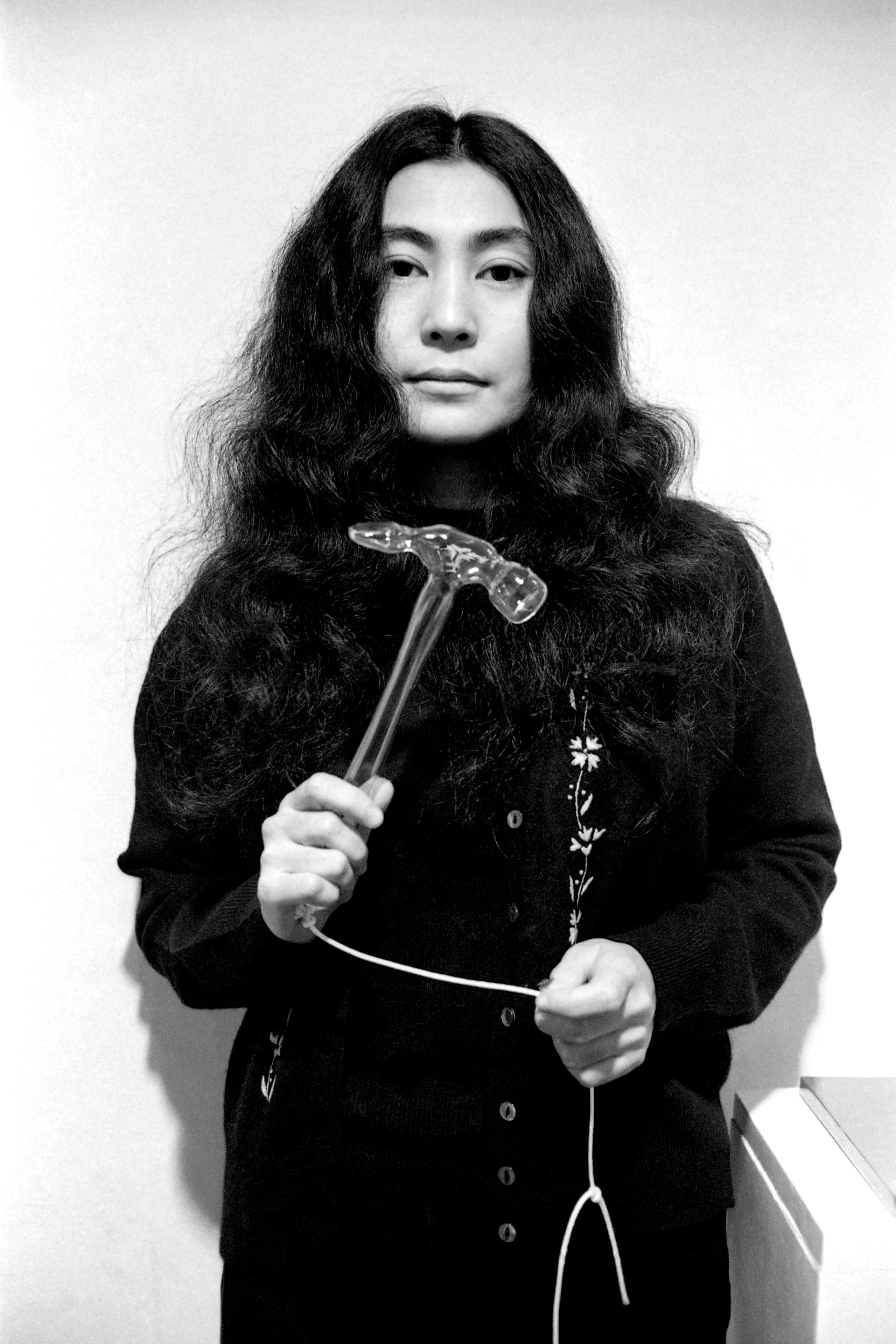Image may contain Yoko Ono Adult Person Face Head Photography Portrait Body Part Finger Hand Device and Hammer