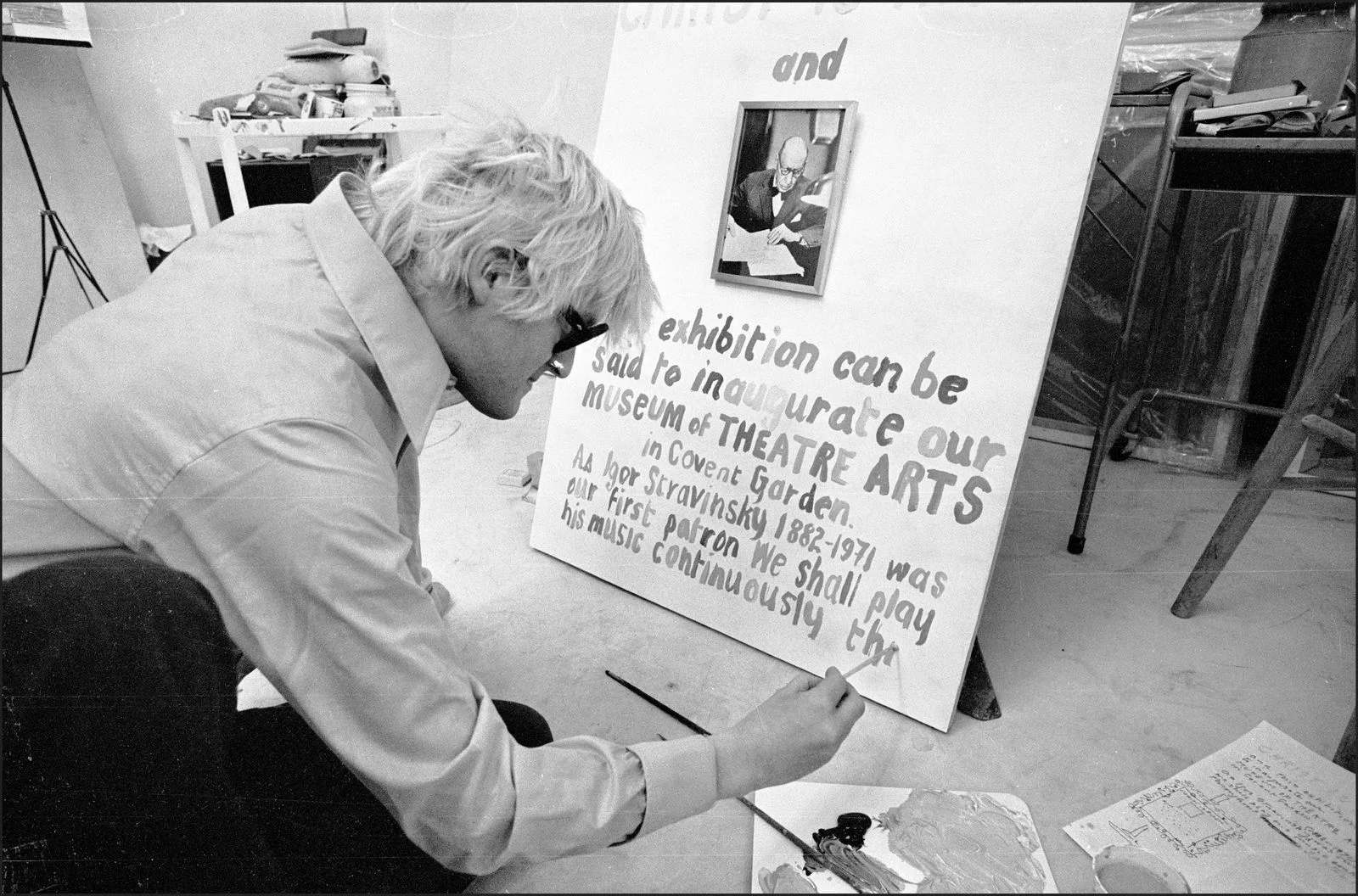 Image may contain David Hockney Poster Adult Person Body Part Finger Hand Face Head and Photography