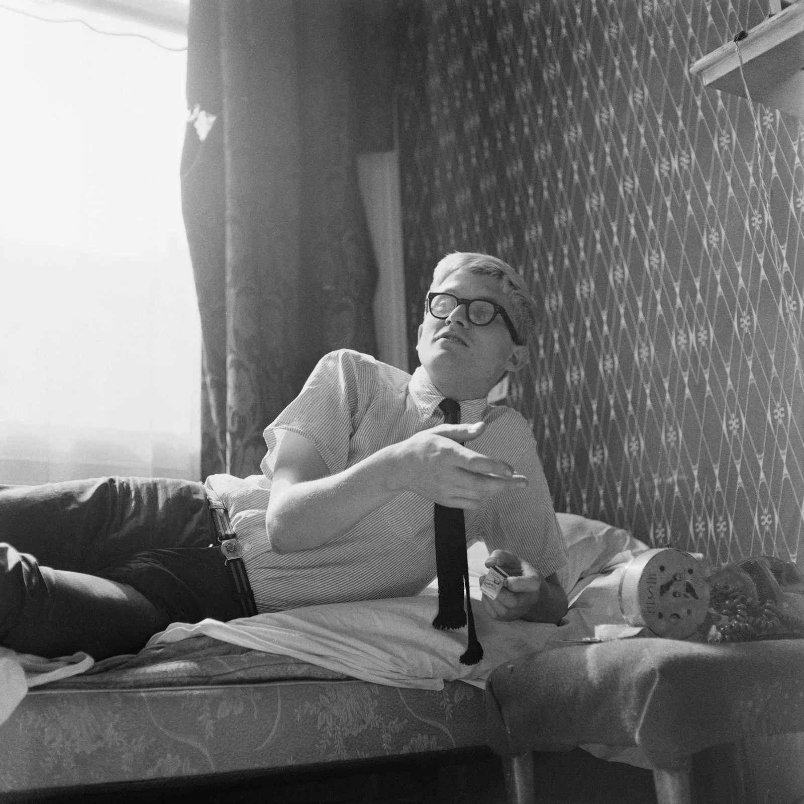 Image may contain David Hockney Face Head Person Photography Portrait Accessories Glasses Couch and Furniture