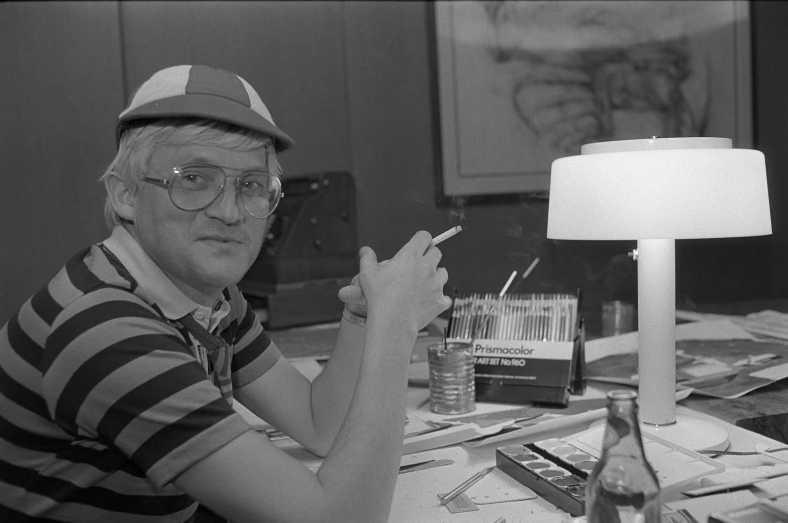 Image may contain David Hockney Body Part Finger Hand Person Adult Head Face Accessories Glasses Clothing and Hat
