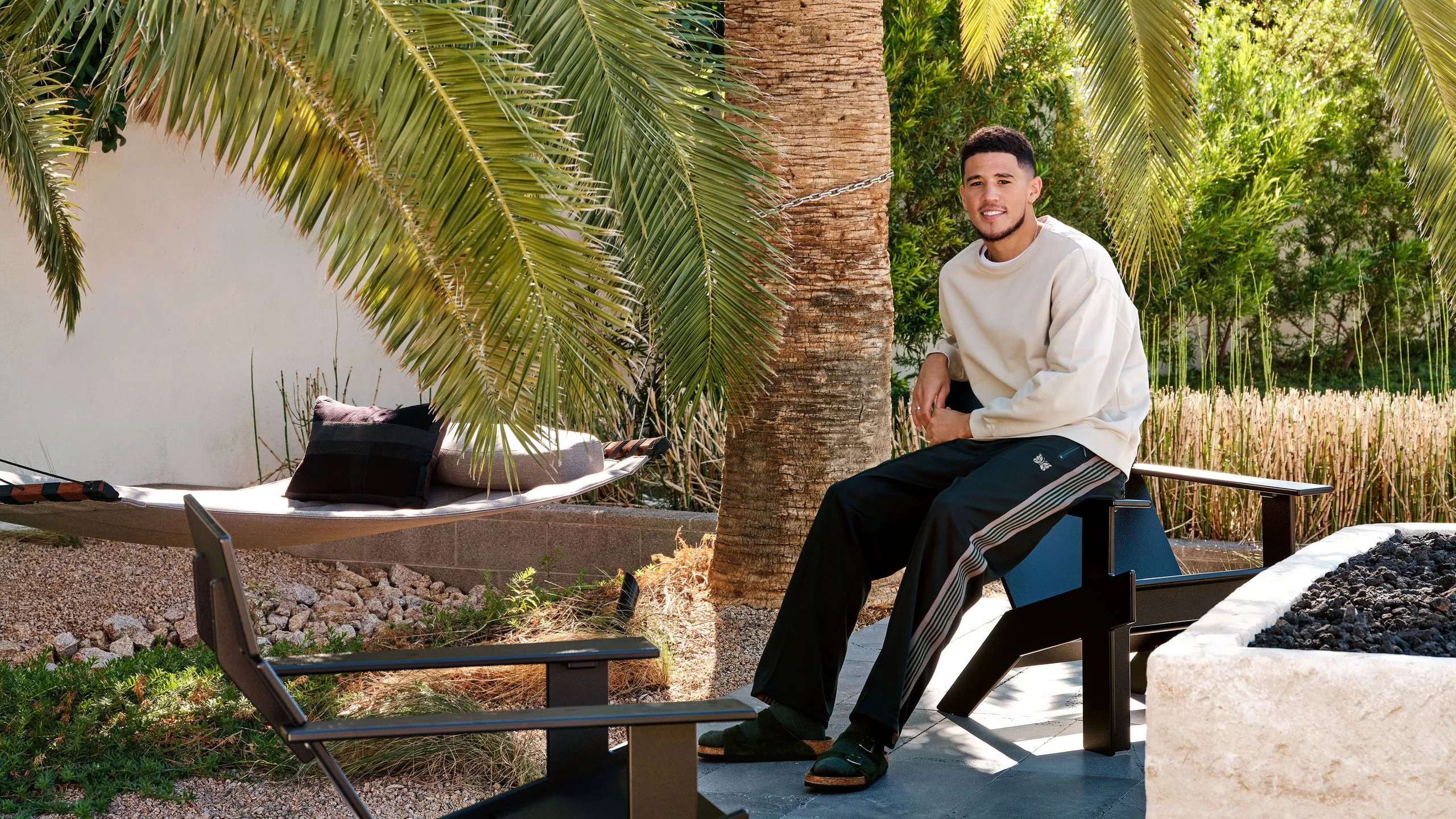 Image may contain Human Person Devin Armani Booker Palm Tree Arecaceae Tree Plant and Flagstone