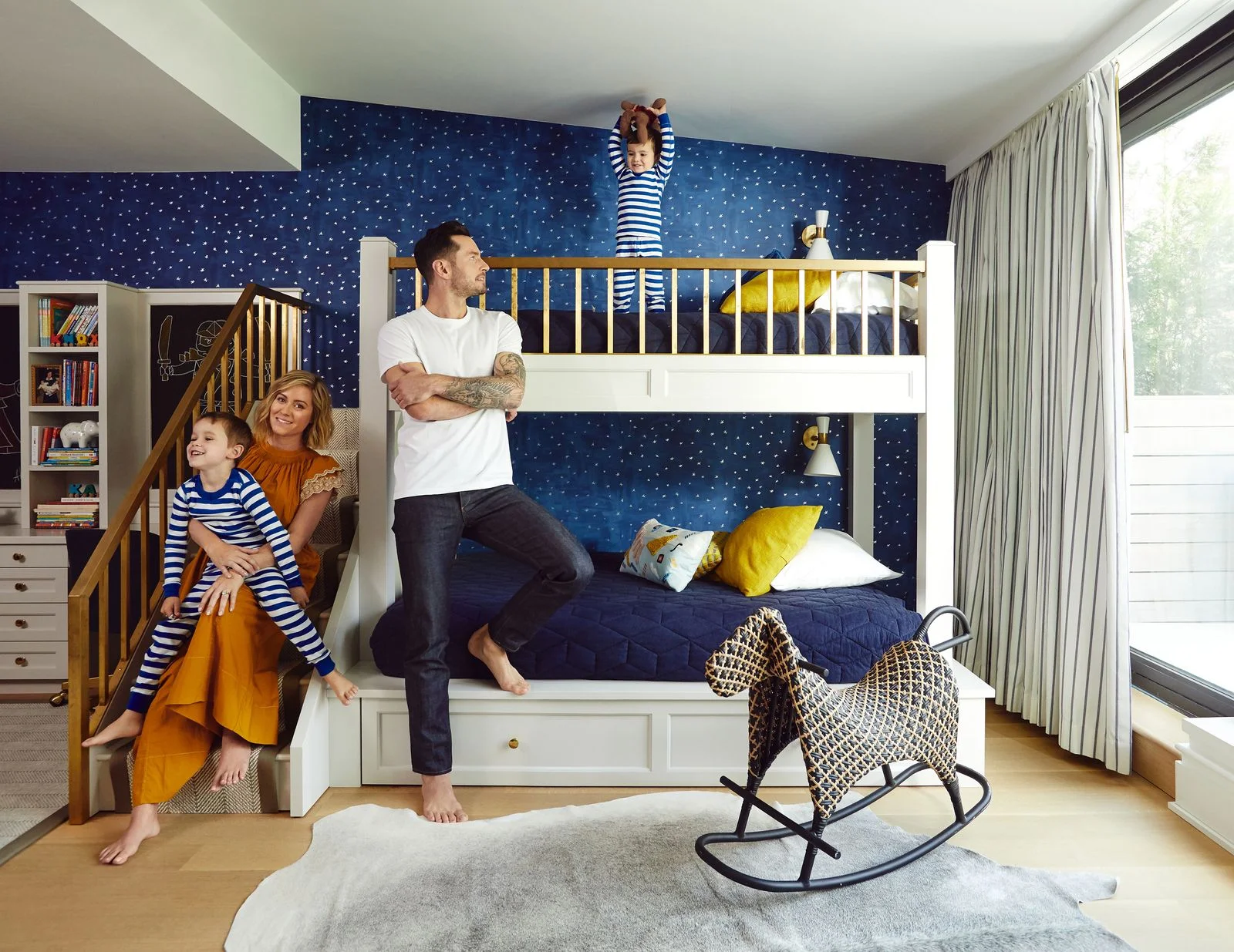 Image may contain Furniture Human Person Bed Bunk Bed Interior Design Indoors Flooring and Rug