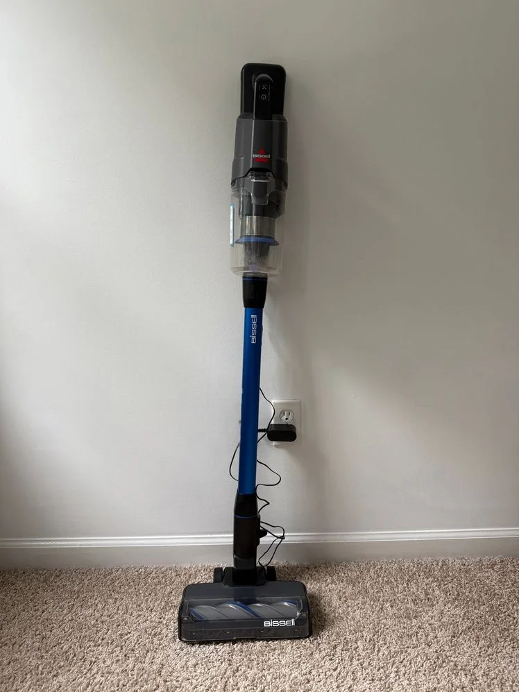 Bissell PowerClean FurFinder Vacuum against a wall on carpeted floors.