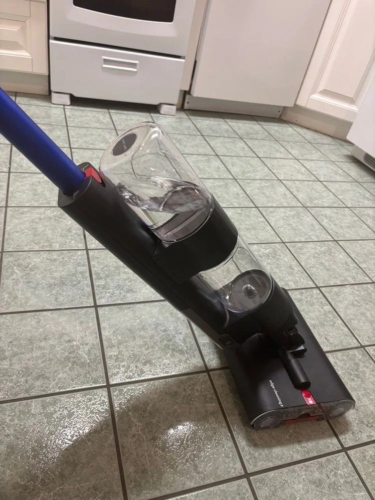 Dyson WashG1 Wet Cleaner being used on a tile floor.