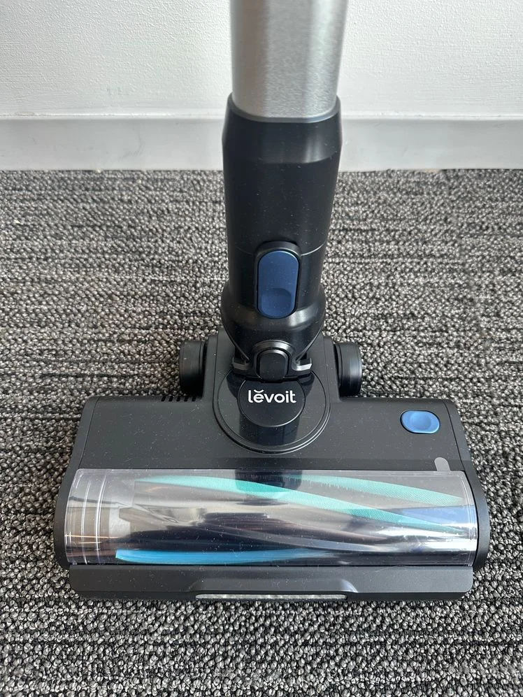 Head and body of the Levoit LVAC-300 Stick Vacuum against a carpeted floor.