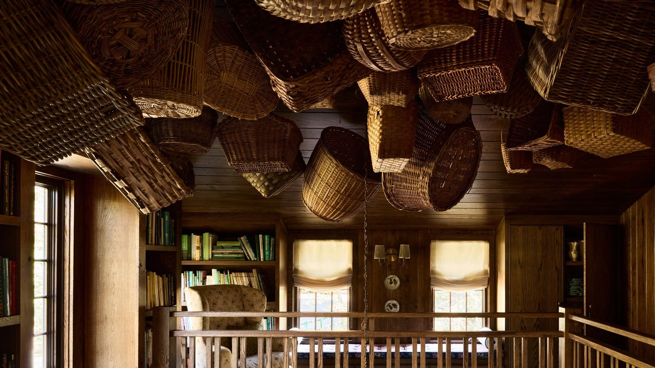 Ceiling with assorted woven baskets hanging from it.