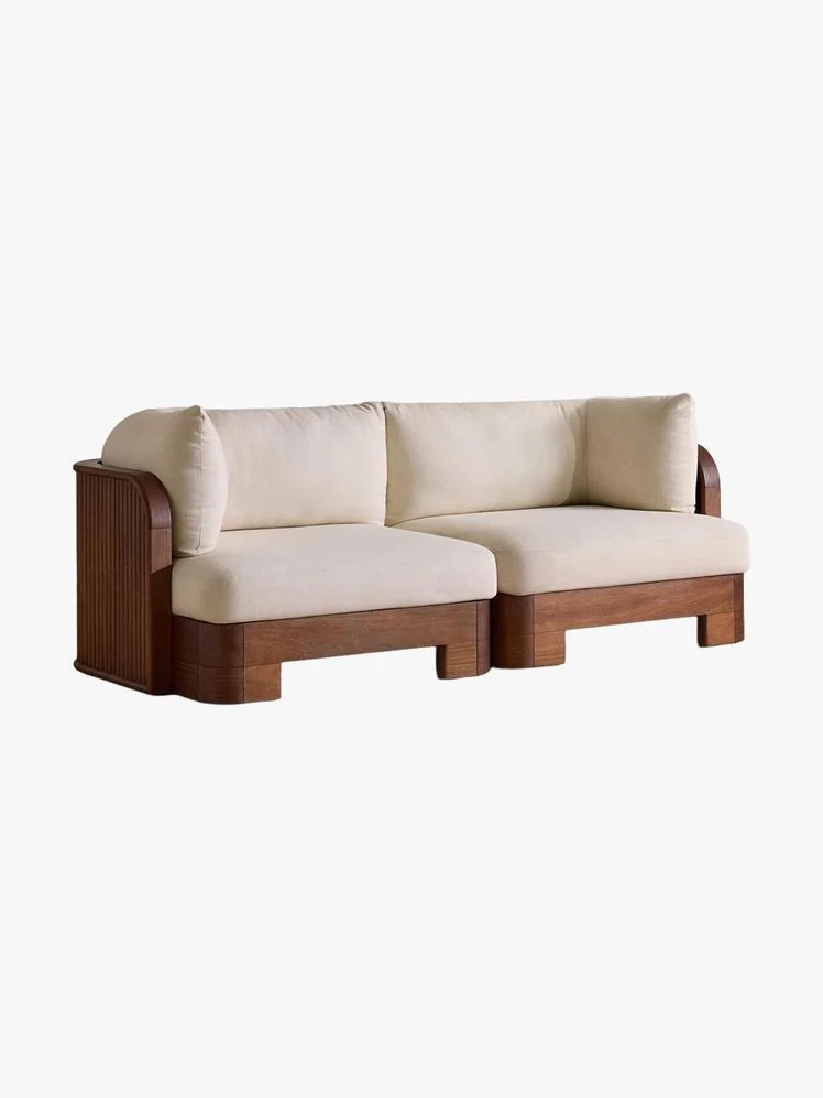 Sofa with white cushions and fluted wood frame.