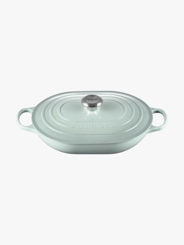 Sage green cast iron oval casserole dish.