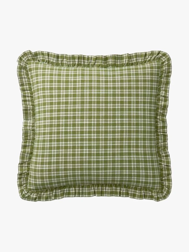 Green plaid pillow with ruffled edges.