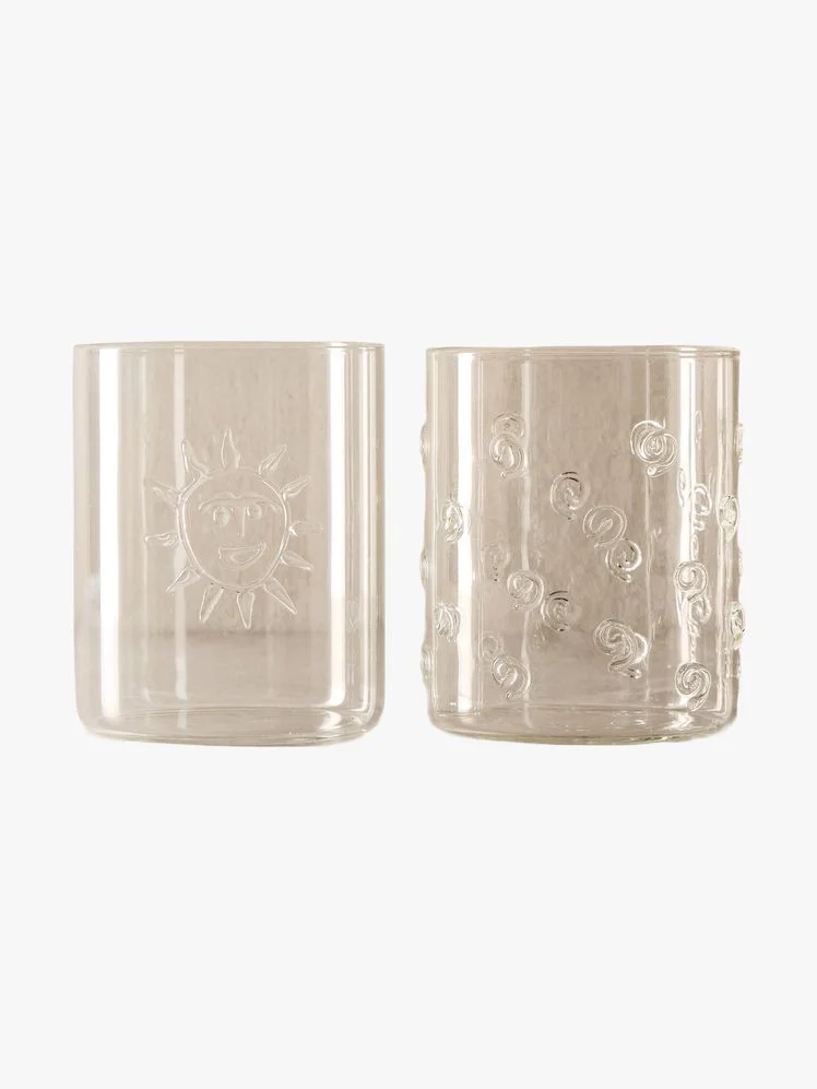 Two old fashioned glasses with decorative details.