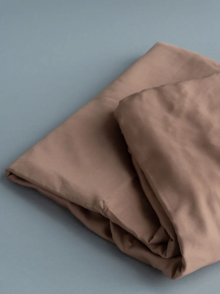 Closeup of folded pink sheets.