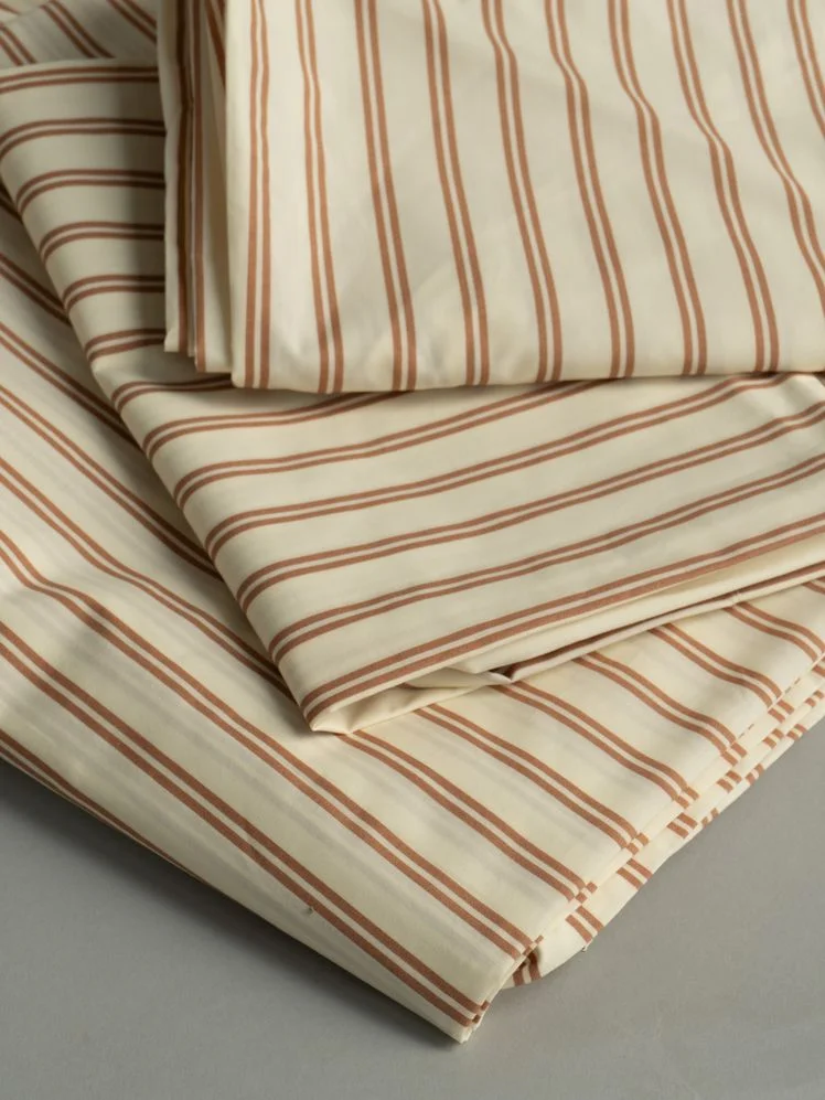 Set of striped sheets in a folded stack.