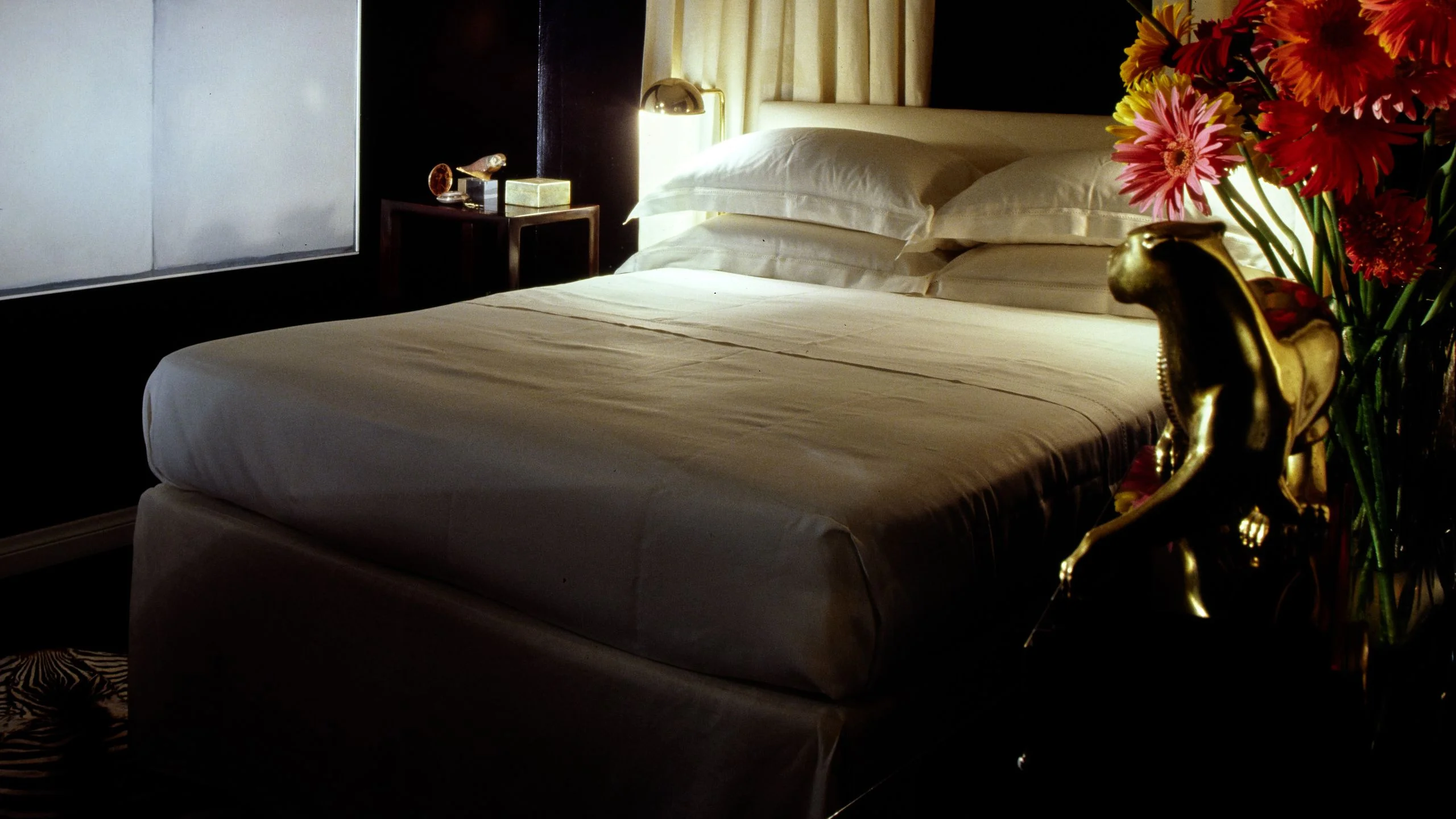 Moody bedroom with white sheets.