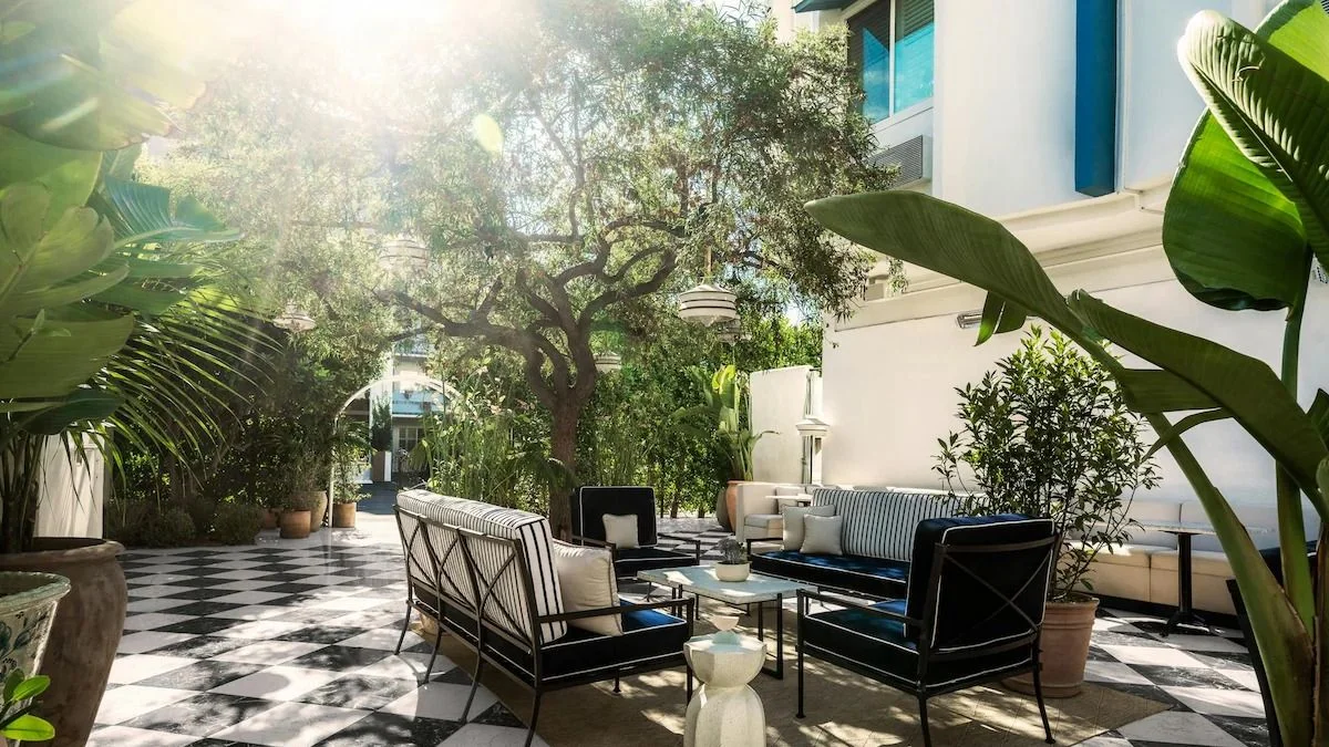 An outdoor living space with checkerstyle floors and patio furniture.